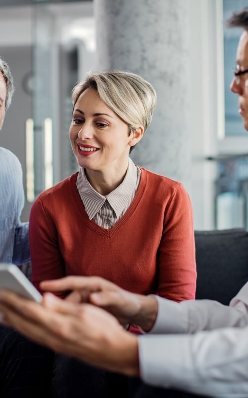 happy-mid-adult-couple-using-touchpad-with-their-financial-consultant-in-the-office-.jpg